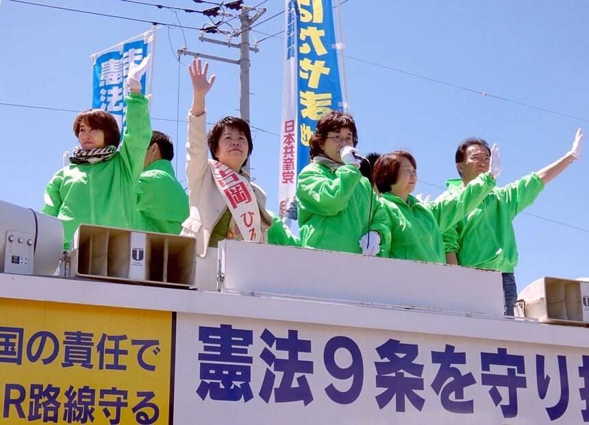 日本共産党の躍進を訴える党市議団と聴衆の声援にこたえる吉岡ひろ子さん（前列左から2人目）